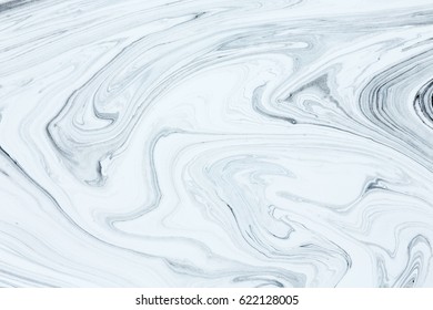 White And Black Paint Mixing Together Creating Shapes.