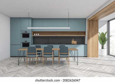 White And Blue Kitchen Space With Dining Table, Linear Light, Loggia, Parquet Flooring And Minimalist Modular Cabinet With Grey Splashback. Concept Of Modern Interior Design. 3d Rendering