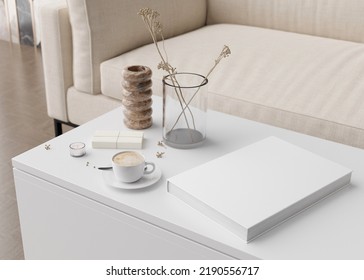 White Book Cover Mock Up With Coffee Cup, Vase And Other Home Accessories On White Table. Blank Template For Your Design. Book Or Catalogue Cover Presentation. 3D Rendering