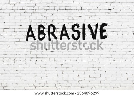 White brick wall with inscription abrasive handwritten with black paint Stock photo © 