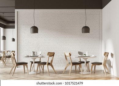 White cafe interior with a wooden floor, round white tables and gray and wooden chairs. 3d rendering mock up