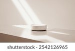 White cylindrical object sits on a smooth, white surface, illuminated by sunlight casting soft shadows. Background photos for advertising product photo background purposes.