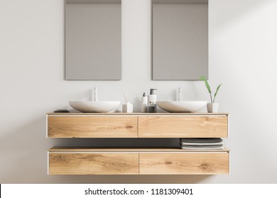 White double sink standing on a wooden vanity unit in a white wall bathroom with two vertical mirrors. Relaxation and self care concept. 3d rendering - Powered by Shutterstock