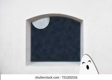 White Ghost With Moon On Clerestory Window On White Wall Background