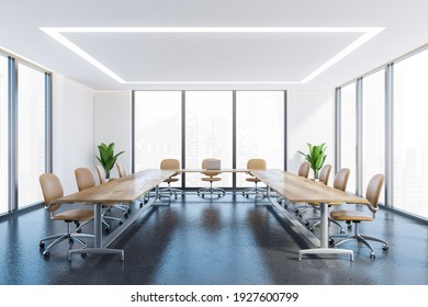 White And Grey Office Conference Room With Wooden U-shape Table, Leather Chairs And Windows. Wooden Minimalist Furniture And Plants, Grey Floor. 3D Rendering, No People