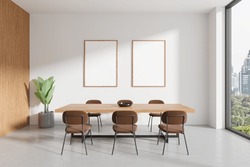 White Home Living Room Interior With Table And Brown Chairs, Concrete Floor. Eating Space With Panoramic Window On Bangkok. Two Mock Up Canvas Posters In Row. 3D Rendering