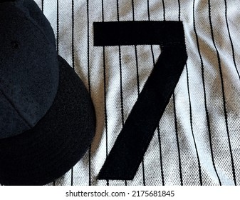 A White Home Pinstripe Number Seven Baseball Jersey And Cap. The Original Image Was Converted To A Simulated Water Color Painting In Post Production. 