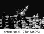 White king chess pieces destroy black king chess pieces over the chess board. Leader, plan, fight, destroy, win, lose concept.
