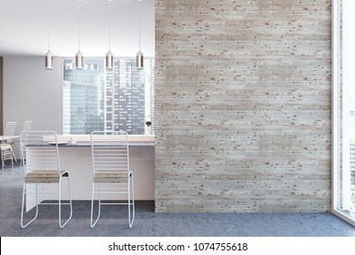 White kitchen interior with a concrete floor, white bar table and chairs standing near it. A mock up wall to the right. 3d rendering