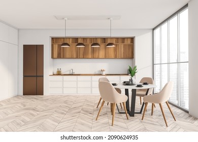 White Kitchen With Wood Materials, Parquet Flooring, Brick Backsplash, Copper Fridge, Minimalist Cabinet And Round Dining Table With Four Beige Chairs. Concept Of Modern Interior Design. 3d Rendering