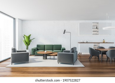 White Living Room With Green Sofa And Grey Armchairs, Coffee Table On Carpet, Parquet Floor. Living Room With Kitchen Set And Dining Table, 3D Rendering No People