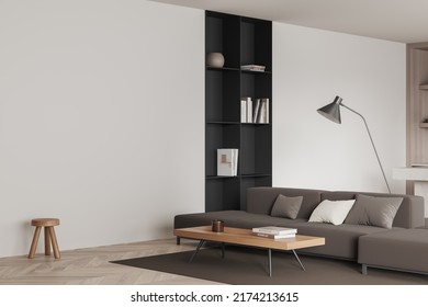 White living room interior with sofa, side view, carpet on hardwood floor. Shelf and coffee table with decoration. Mockup empty wall. 3D rendering