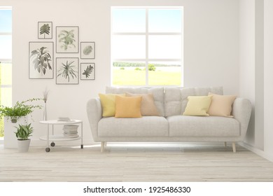 White Living Room With Sofa And Summer Landscape In Window. Scandinavian Interior Design. 3D Illustration