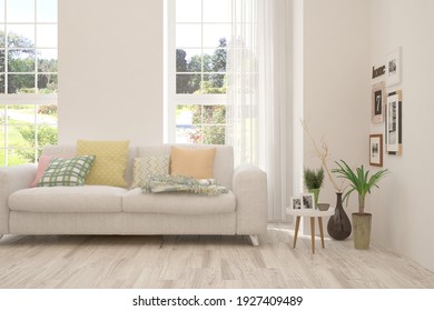 White Living Room With Sofa And Summer Landscape In Window. Scandinavian Interior Design. 3D Illustration