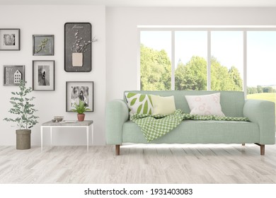 White Living Room With Sofa And Summer Landscape In Window. Scandinavian Interior Design. 3D Illustration