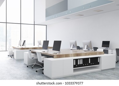 White Open Space Office Corner With White And Wooden Tables And Rows Of Computers On Them. A Two Floor Office With A Loft Window. 3d Rendering Mock Up