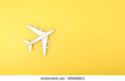 White Plane On Yellow Background. Flat Lay Design Of Travel Concept. 3d Rendering.