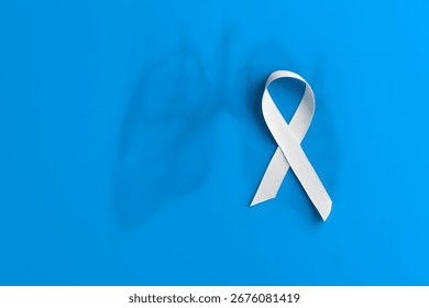 White ribbon with lung outline on blue background, symbolizing lung cancer awareness, support, and advocacy during November health campaigns. - Powered by Shutterstock - Get 15% off with code: PIKWIZARD15