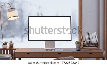 White screen computer with book rack on wooden table aside lamp and snowfall over glass wall window. Advertise Mockup, 3D Rendering, 3D illustration.