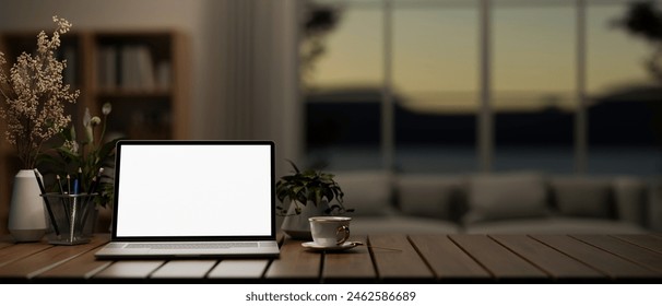 A white screen laptop computer mockup, a coffee cup, and potted plants on a wooden table in a modern dark living room. 3d render, 3d illustration - Powered by Shutterstock