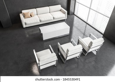 White Sofa And Chairs In Dark Light Business Office Top View, Waiting Room For Clients With A Big Window, View On Skyscrapers. Black Walls And Floor With White Furniture 3D Rendering, No People