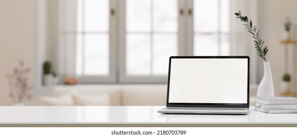 White Tabletop With Laptop Computer Blank Desktop Mockup, Ceramic Vase And Copy Space For Montage Your Product Display Over Blurred Minimal Living Room In Background. 3d Rendering, 3d Illustration