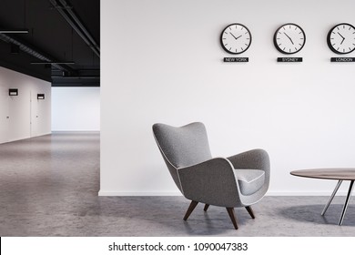 White Wall Office Waiting Room With A Number Of Clocks And Gray Armchairs Near The Coffee Table. A Close Up. 3d Rendering Mock Up