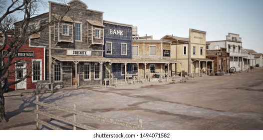 Wide angled view of a rustic antique Western town with various businesses. 3d rendering