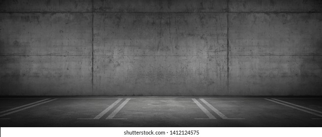 Wide Urban Concrete Garage Dark Wall And Car Parking Floor With Spot Light