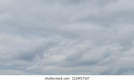 The Winter Morning Sky Had Fluffy White And Gray Clouds Floating In The Dim Sky. 