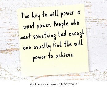Wise quotation handwritten on yellow sticky note hanging on wooden wall