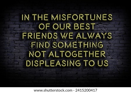 Wise quotation as light neon sign on brick wall