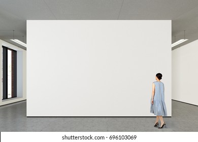 Woman Looking At Blank Wall In Modern Gallery. Poster Isolated With Clipping Path. 3d Illustration