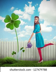 Woman Watering A Four Leaf Clover