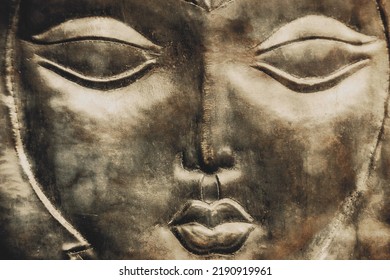 A Woman's Face, A Mask Embossed On Metal.