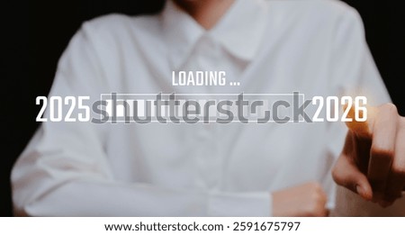A Woman's Hand on Progress Bar Transition from 2025 to 2026, Business concept.