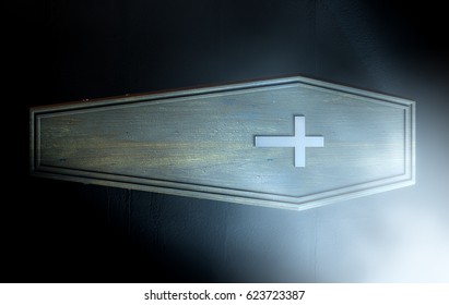 A Wooden Coffin With A Metal Crucifix And Handles Dimly Lit By A Dim Spotlight - 3D Render