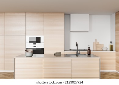 Wooden Cooking Interior With Island Cabinet And Sink, Towel And Plate On Deck, Stove And Oven, Shelves With Kitchenware, Hardwood Floor. Luxury Kitchen With Modern Furniture, 3D Rendering