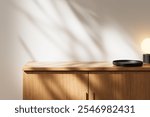 Wooden countertop with black tray and modern lamp casting soft light. Shadows on white background, minimalist presentation concept. 3D Rendering.