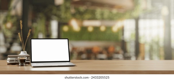 A wooden desk features a white-screen laptop computer mockup and accessories in a modern farmhouse coffee shop. remote workplace concept. 3d render, 3d illustration - Powered by Shutterstock