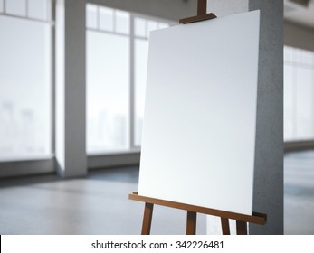 Wooden Easel With A Blank White Canvas In Modern Interior.