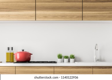 Wooden kitchen countertops with a built in cooker, a pot on it and small plants. Olive oil. Concept of cooking at home and family values. 3d rendering mock up