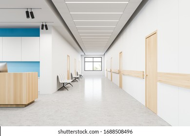 Wooden reception desk with computer standing in stylish hospital corridor with white and blue walls and row of doors and visitors chairs. Concept of healthcare and medicine. 3d rendering