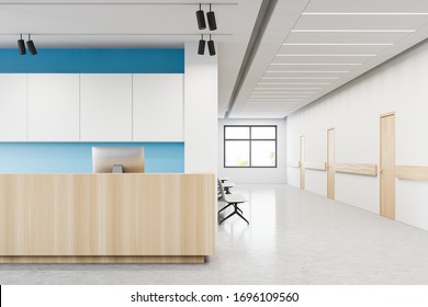 Wooden reception desk with computer standing in stylish hospital hall with white and blue walls and row of closed doors and visitors chairs. Concept of healthcare and medicine. 3d rendering