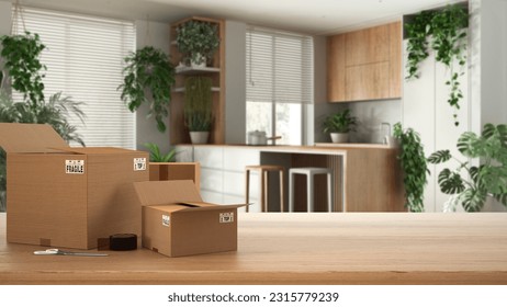 Wooden table, desk or shelf with stack of cardboard boxes over blurred view of minimal kitchen and living room, houseplants interior design, moving house concept with copy space, 3d illustration