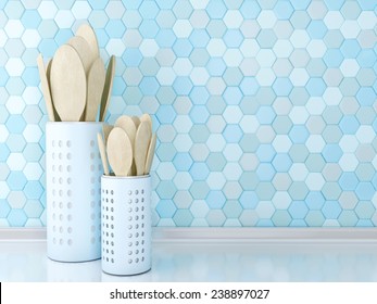 Wooden Utensils On The White Worktop In Front Of Blue Tile Wall.