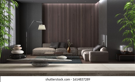 Wooden vintage table shelf with pebble balance and 3d letters making the word feng shui over blurred minimal luxury living room with sofa and carpet, zen concept interior design, 3d illustration