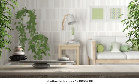Wooden vintage table or shelf with stone balance, over blurred scandinavian living room with wooden sofa and potted ivy plants, feng shui, zen concept architecture interior design, 3d illustration