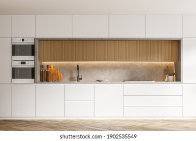 Wooden and white cupboards standing in stylish kitchen with white walls and wooden floor. 3d rendering