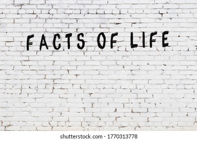 Word Facts Of Life Written With Black Paint On White Brick Wall.